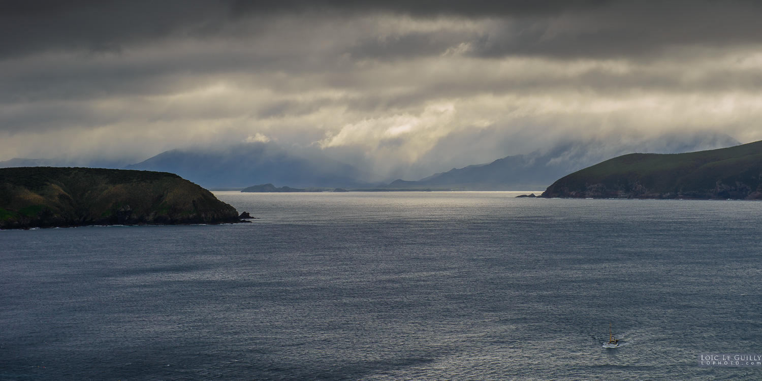 photograph of Maatsuyker Island and a fishing boat